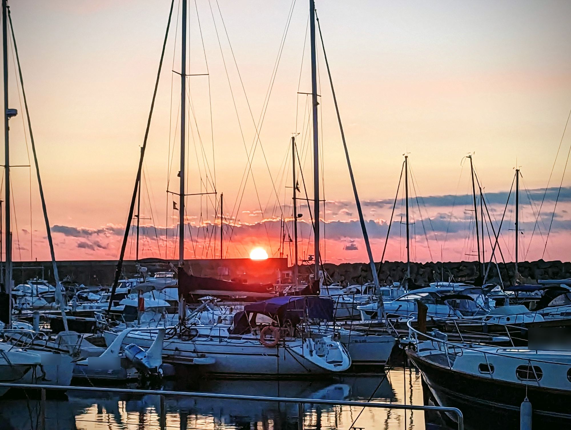 Sunrise between the masts in Marina Palamós