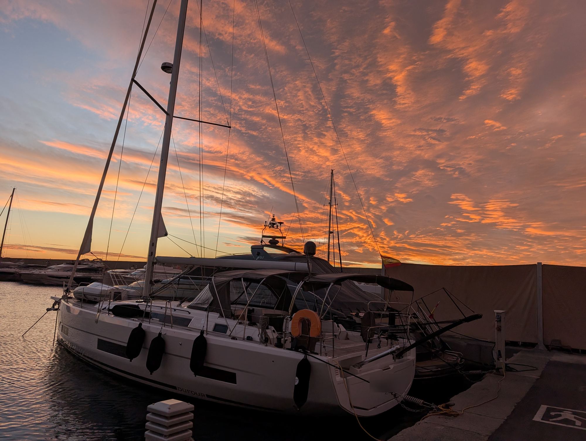 Sailing yacht moored in Marina Palamós on a winter sunrise